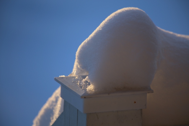 Some accumulated snow on the post at the top of the front staircase ramp at my parent's